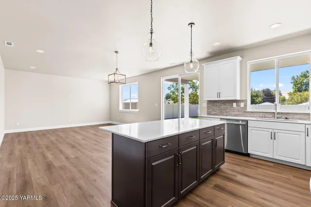 a kitchen with sink cabinets and wooden floor