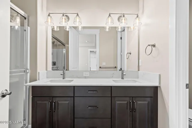 a bathroom with a double vanity sink mirror and double