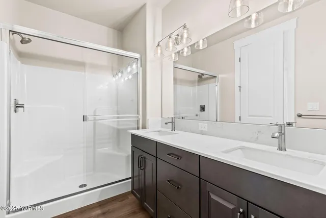 a bathroom with a shower sink and mirror