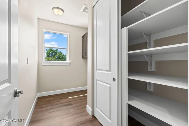 a view of an entryway with wooden floor