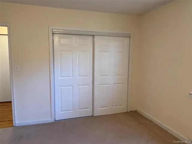 an empty room with closet area