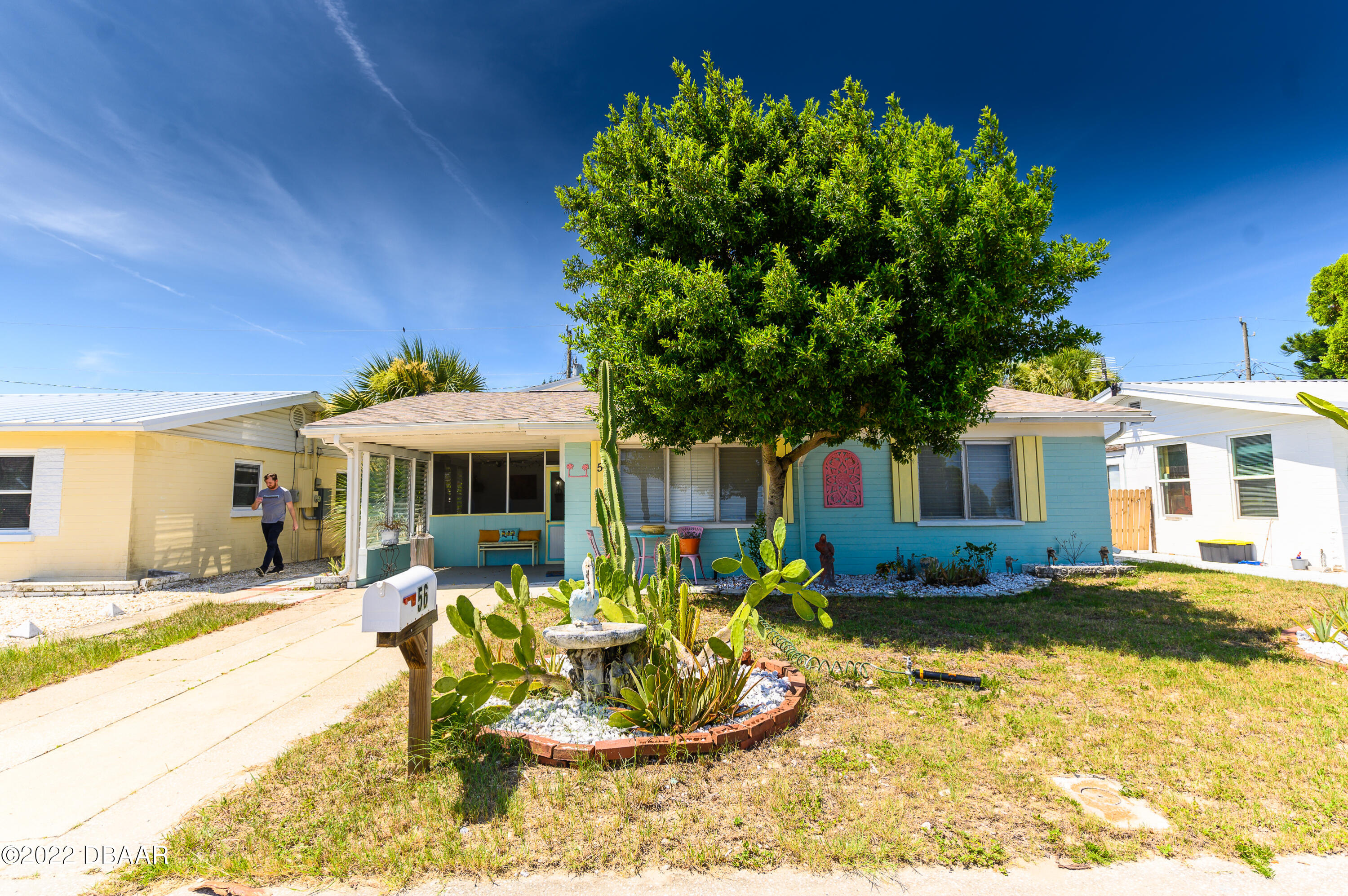 56 Margaret Road Ormond Beach, FL 32176 - Photo 1 of 32 a front view of a house with a yard outdoor seating and covered with trees