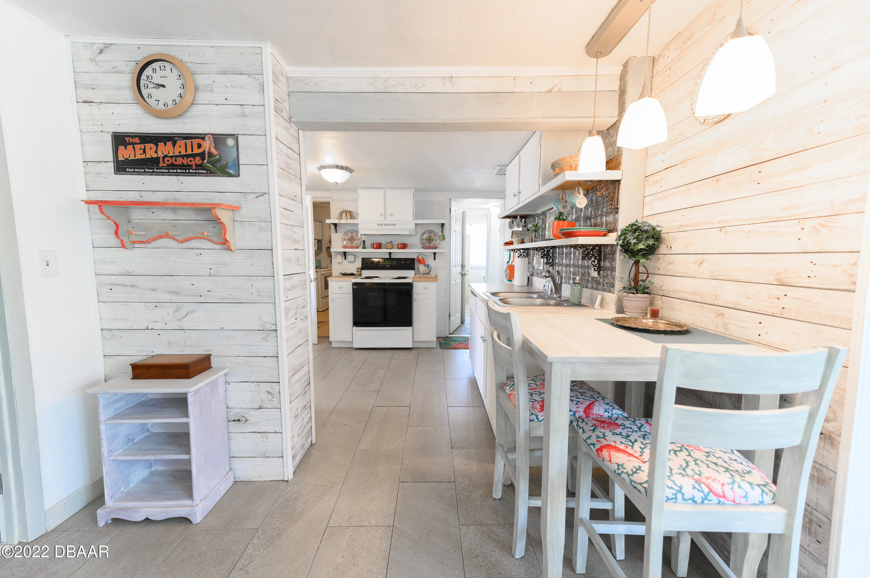 56 Margaret Road Ormond Beach, FL 32176 - Photo 12 of 32 a utility room with stainless steel appliances and furniture