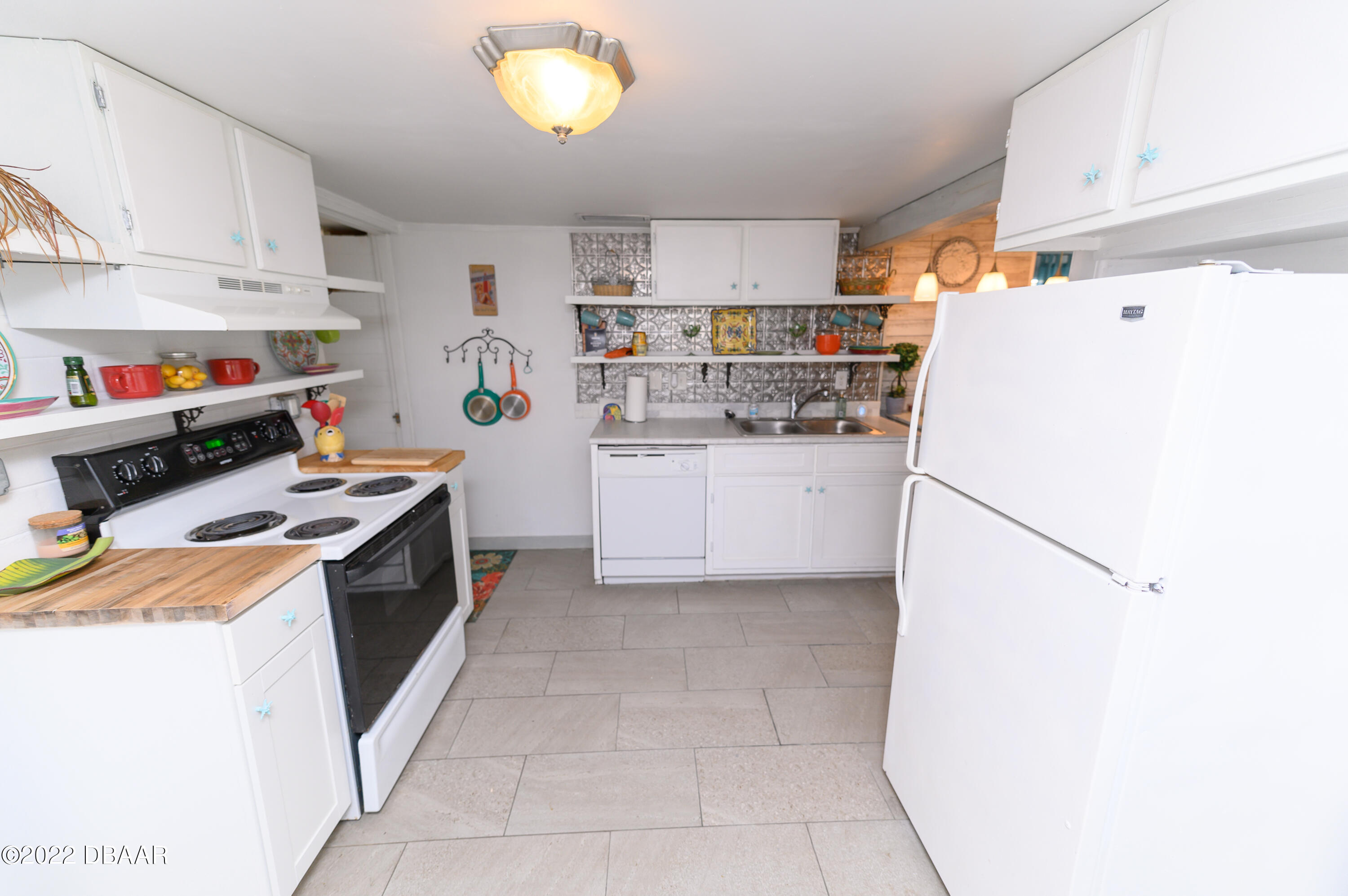 56 Margaret Road Ormond Beach, FL 32176 - Photo 13 of 32 a kitchen with a refrigerator a stove top oven and a sink