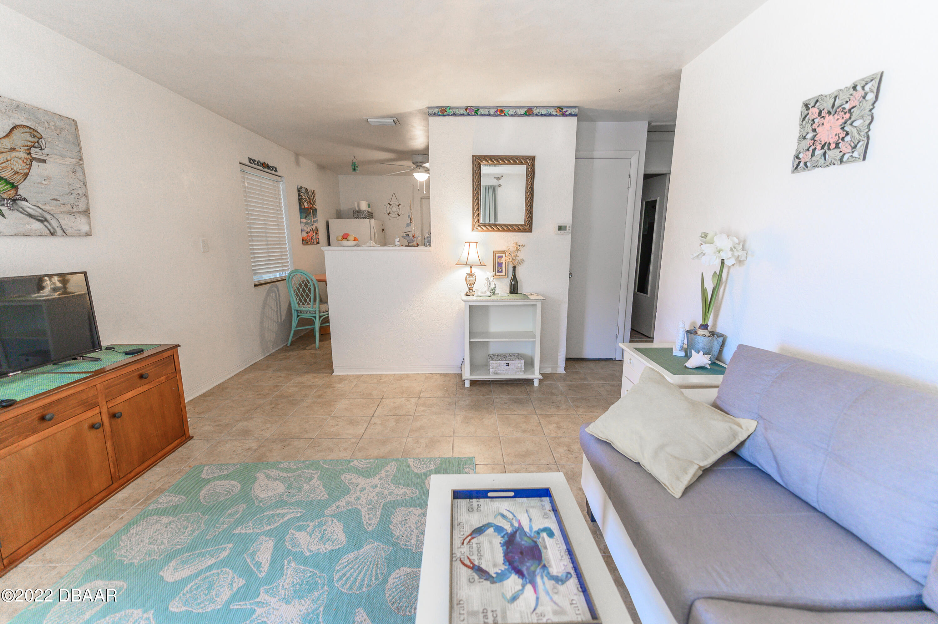 56 Margaret Road Ormond Beach, FL 32176 - Photo 22 of 32 a living room with furniture and a dresser