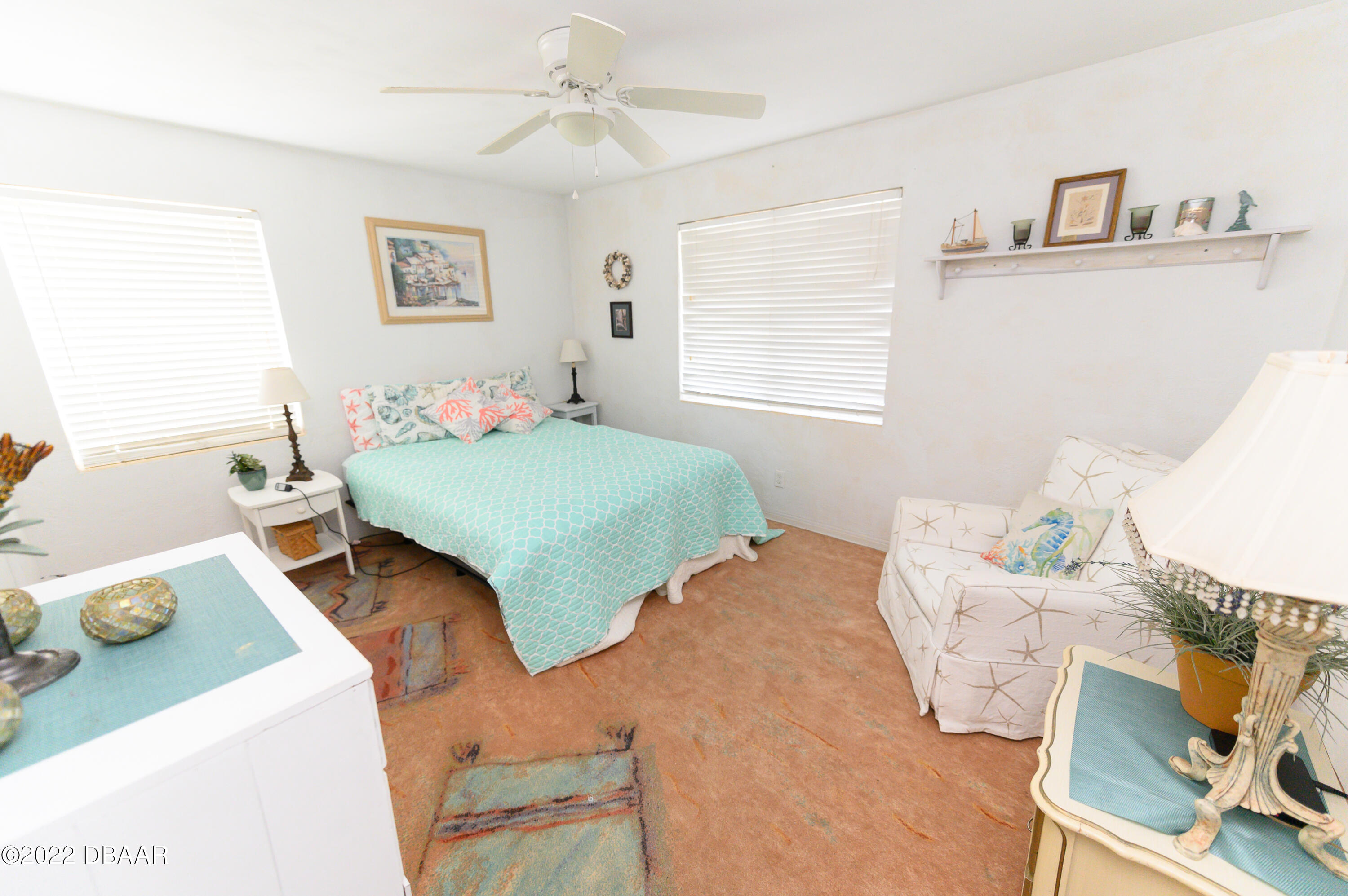 56 Margaret Road Ormond Beach, FL 32176 - Photo 24 of 32 a bedroom with a bed and wooden floor