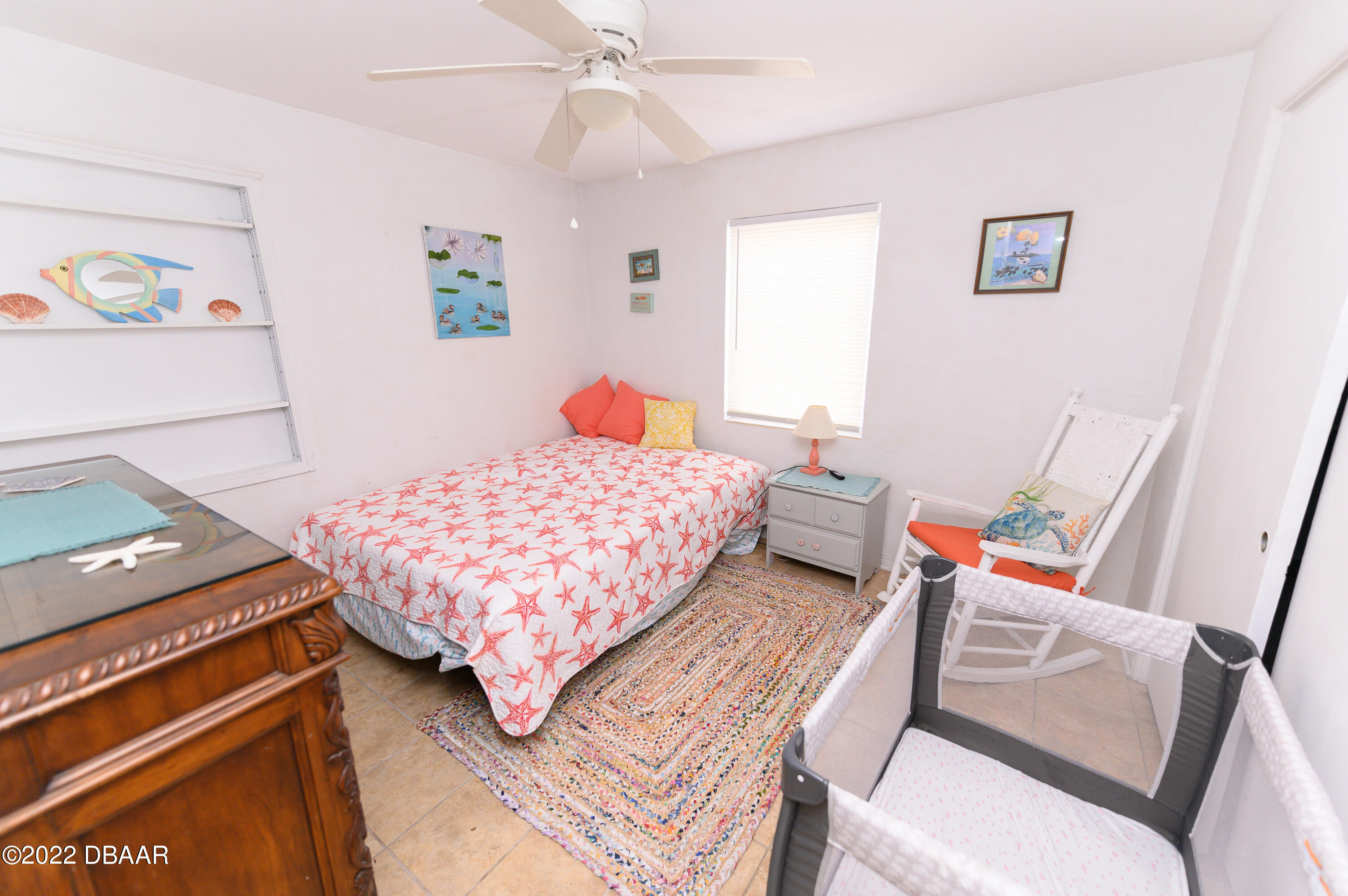 56 Margaret Road Ormond Beach, FL 32176 - Photo 25 of 32 a bedroom with a bed and wooden floor