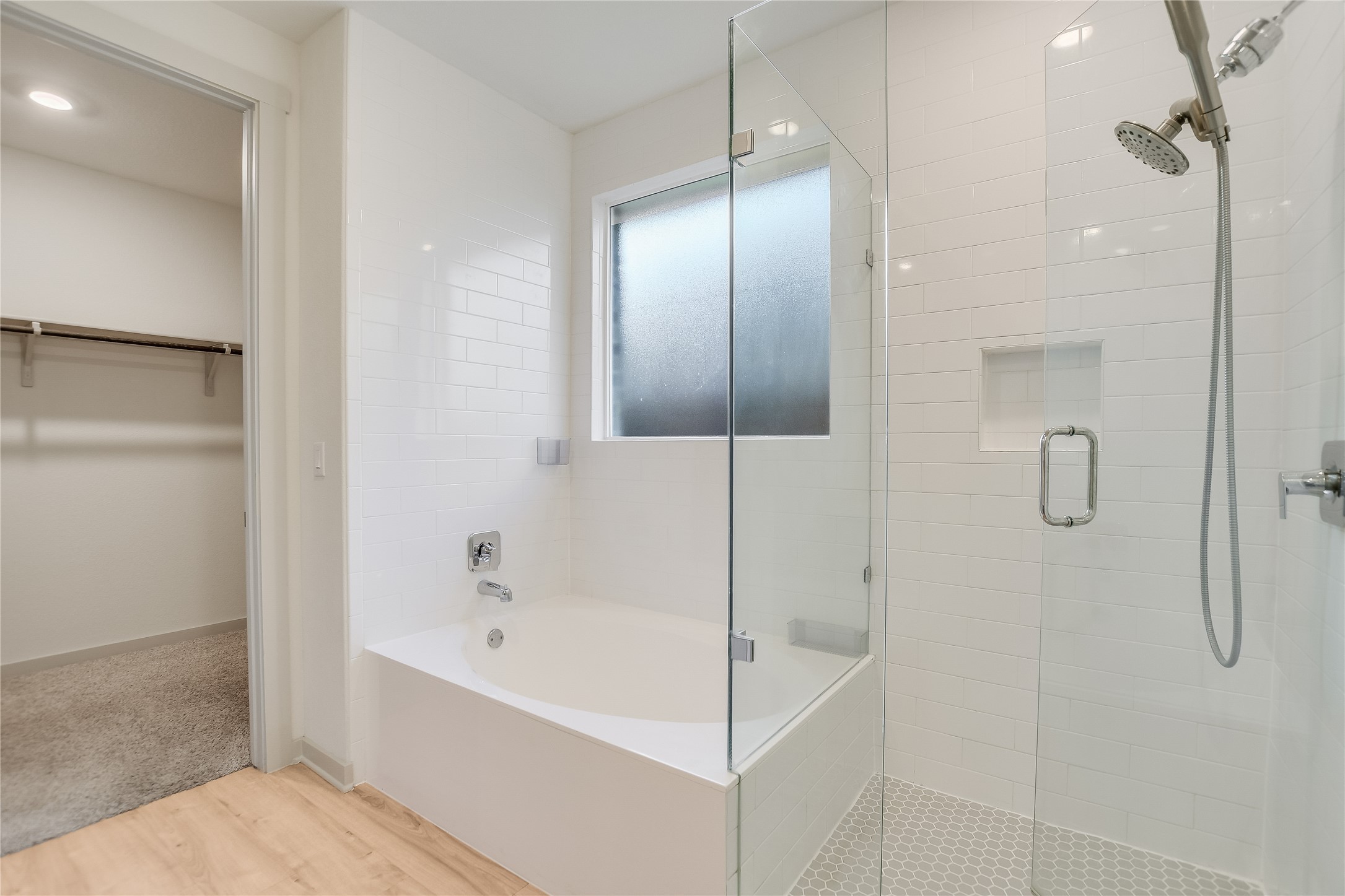 2244 Alamar Walk Leander, TX 78641 - Photo 9 of 22 a bathroom with a bathtub and shower