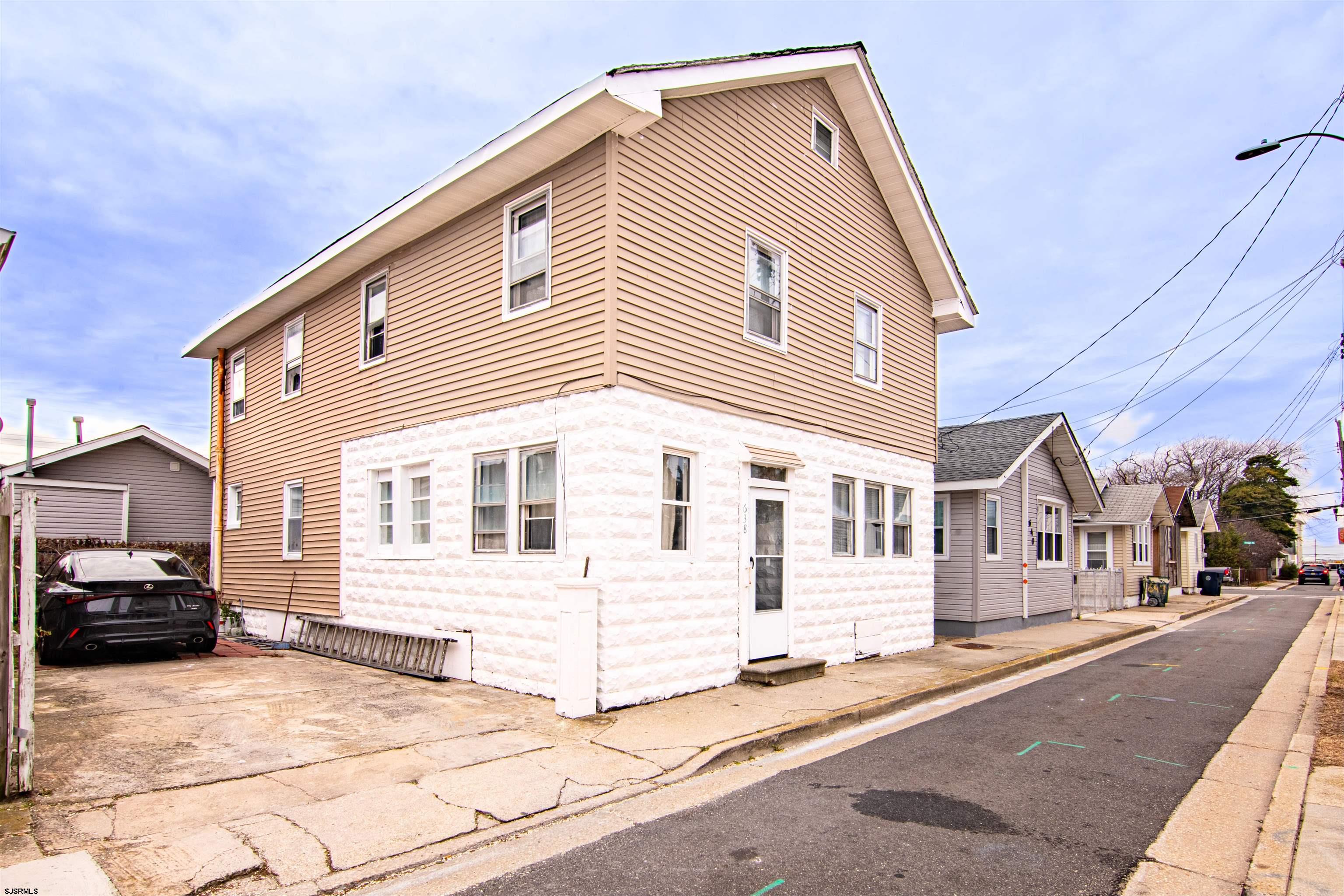 a view of a car park in front of a house