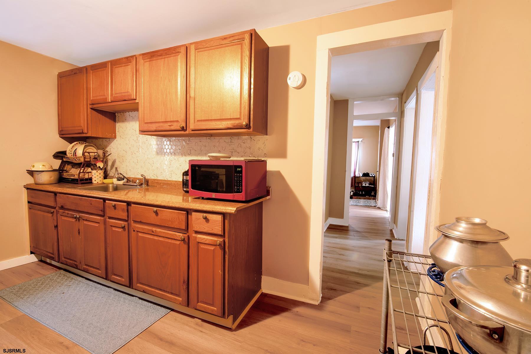 638 Wisteria Road Atlantic City, NJ 08401 - Photo 21 of 33 a kitchen with stainless steel appliances granite countertop a sink and cabinets