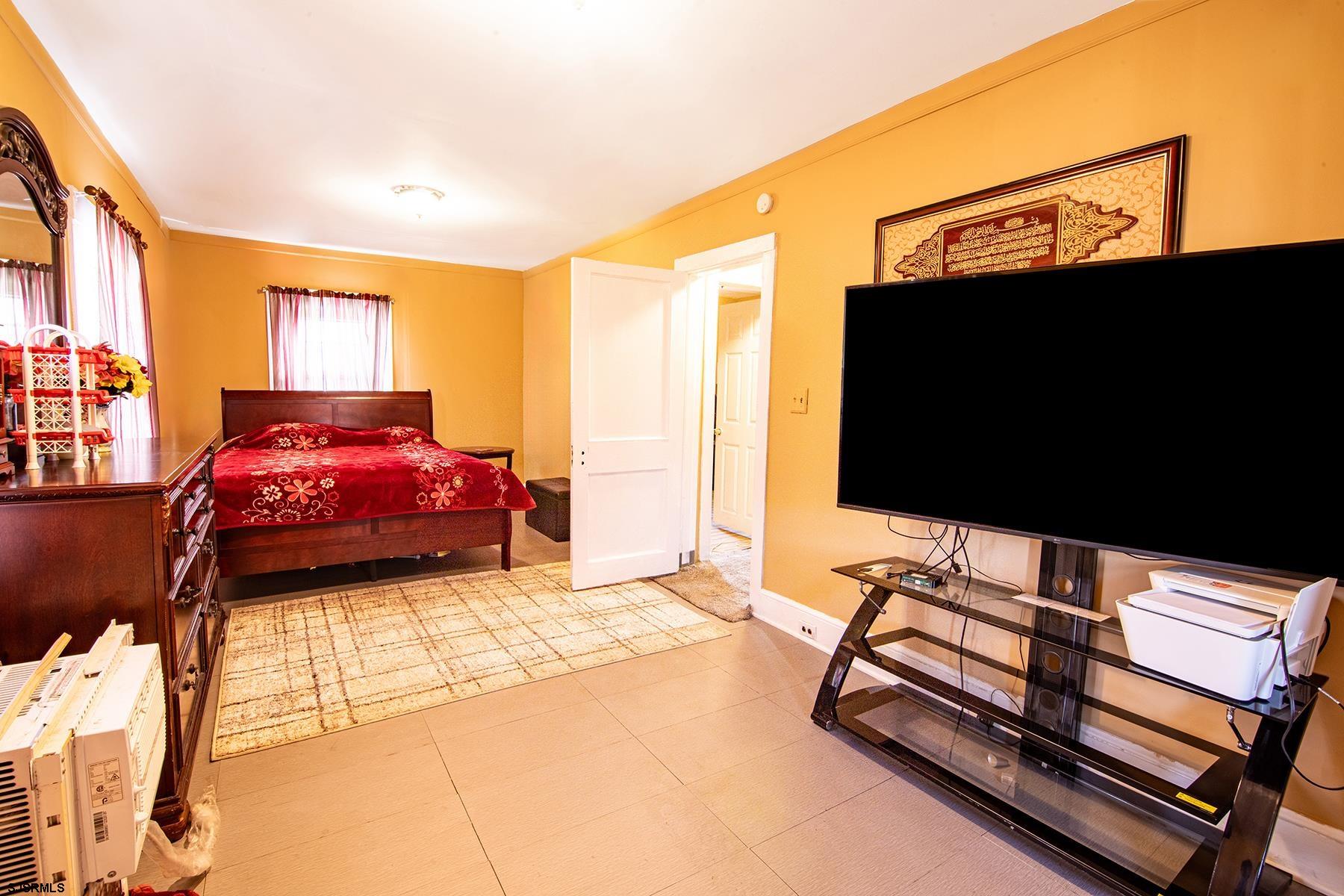638 Wisteria Road Atlantic City, NJ 08401 - Photo 26 of 33 a bedroom with a bed and a flat tv screen on the dresser