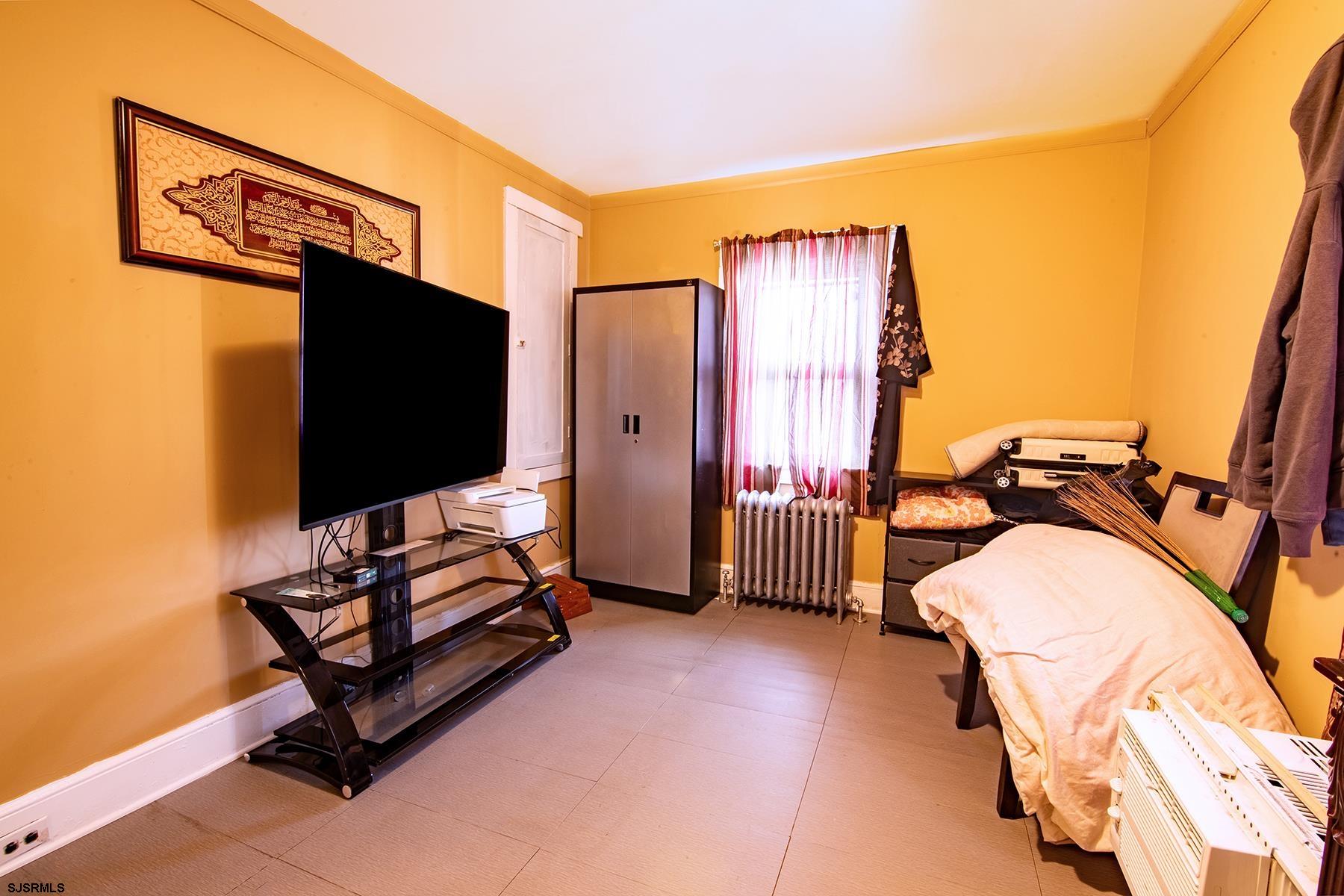 638 Wisteria Road Atlantic City, NJ 08401 - Photo 27 of 33 a bedroom with a bed and flat screen tv