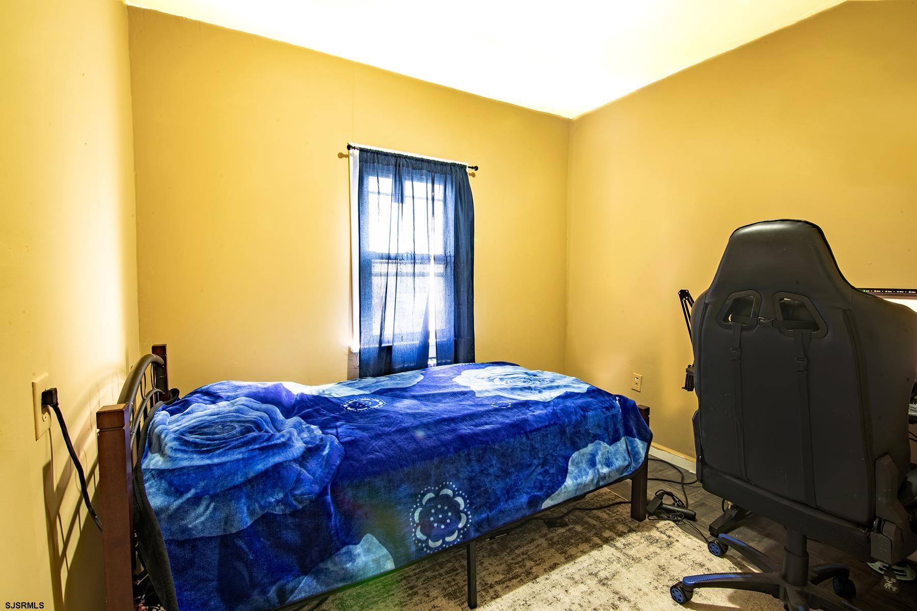 638 Wisteria Road Atlantic City, NJ 08401 - Photo 30 of 33 a bedroom with a bed and wooden floor