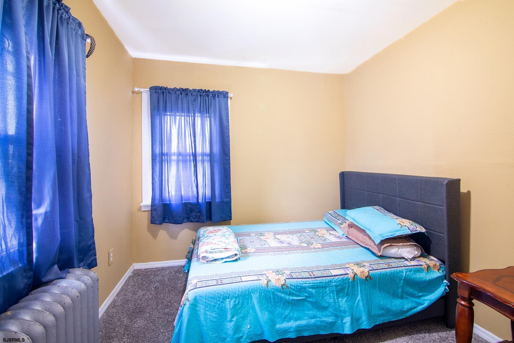 638 Wisteria Road Atlantic City, NJ 08401 - Photo 33 of 33 a bedroom with a bed and wooden floor