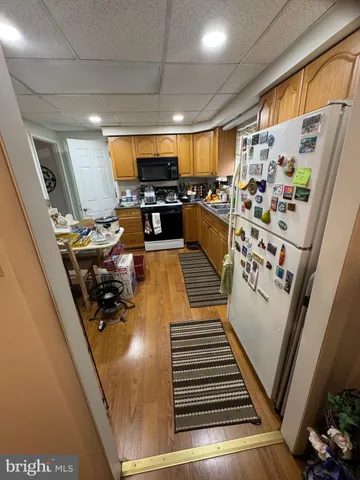 a view of a living room with furniture and a flat screen tv