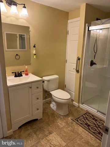 a bathroom with a toilet sink and shower