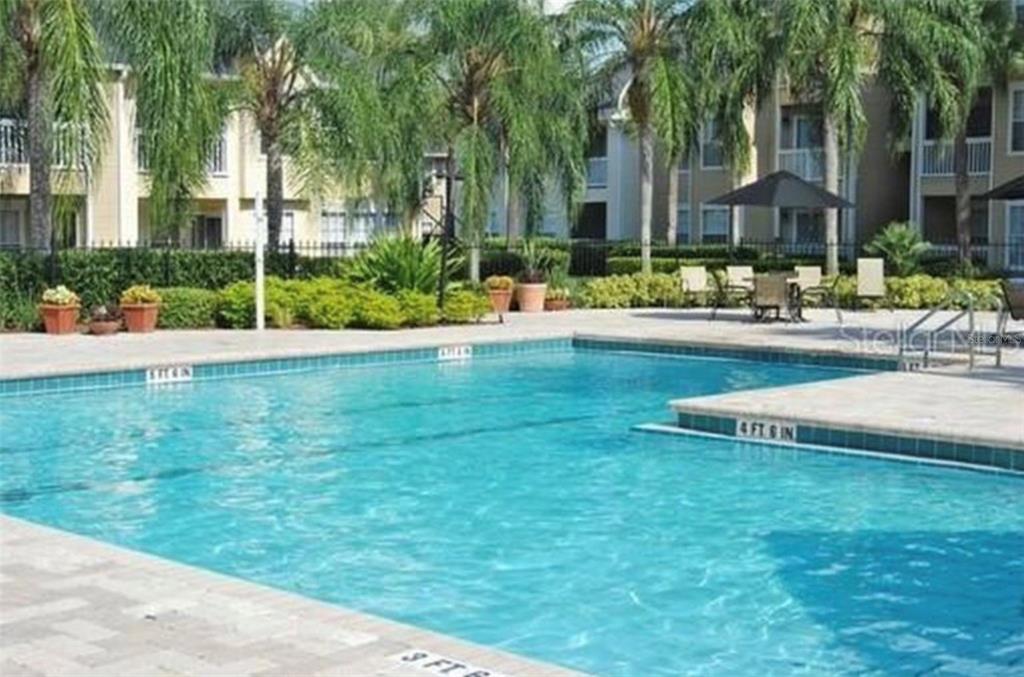 1081 South Hiawassee Road, Unit 723 Orlando, FL 32835 - Photo 17 of 18 a view of swimming pool with outdoor seating and a garden