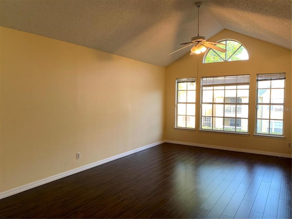 1081 South Hiawassee Road, Unit 723 Orlando, FL 32835 - Photo 3 of 18 an empty room with wooden floor and windows
