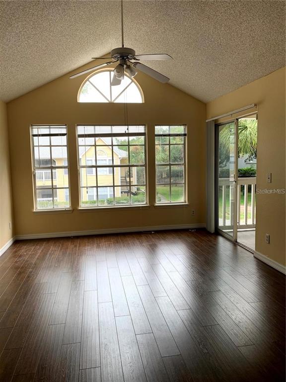1081 South Hiawassee Road, Unit 723 Orlando, FL 32835 - Photo 4 of 18 a view of an empty room with wooden floor and a window