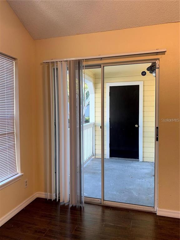 1081 South Hiawassee Road, Unit 723 Orlando, FL 32835 - Photo 9 of 18 a view of a hallway with wooden floor and closet area