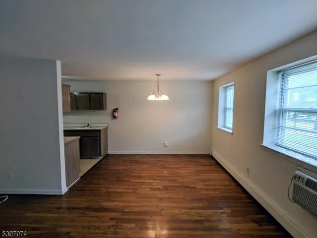 a view of a kitchen with a sink a refrigerator and window