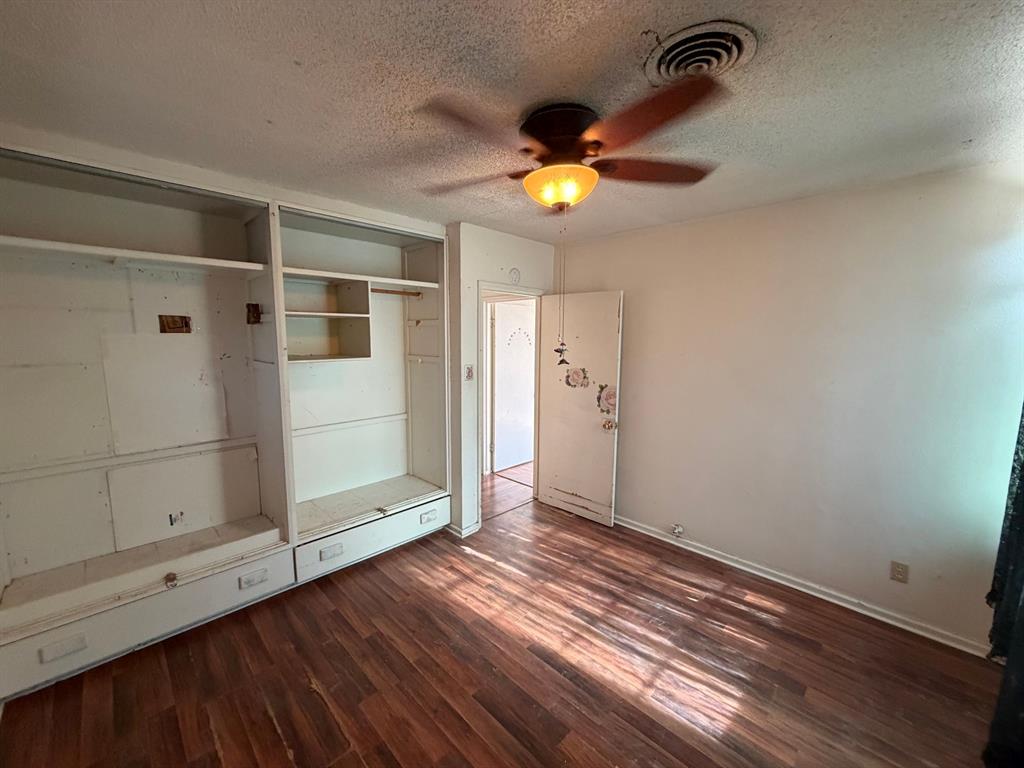 1225 Coit Street Denton, TX 76201 - Photo 13 of 13 a view of an empty room with a window and wooden floor