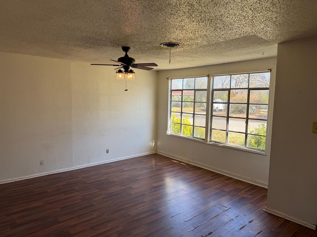 1225 Coit Street Denton, TX 76201 - Photo 5 of 13 wooden floor in an empty room with a window