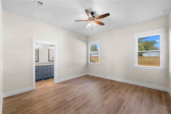 wooden floor in an empty room with a window