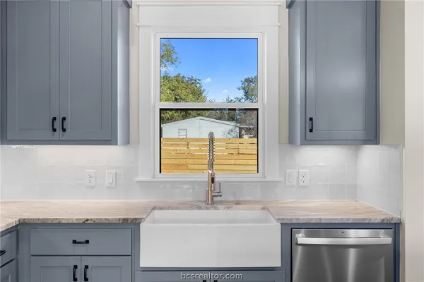 a kitchen with granite countertop a sink and a window