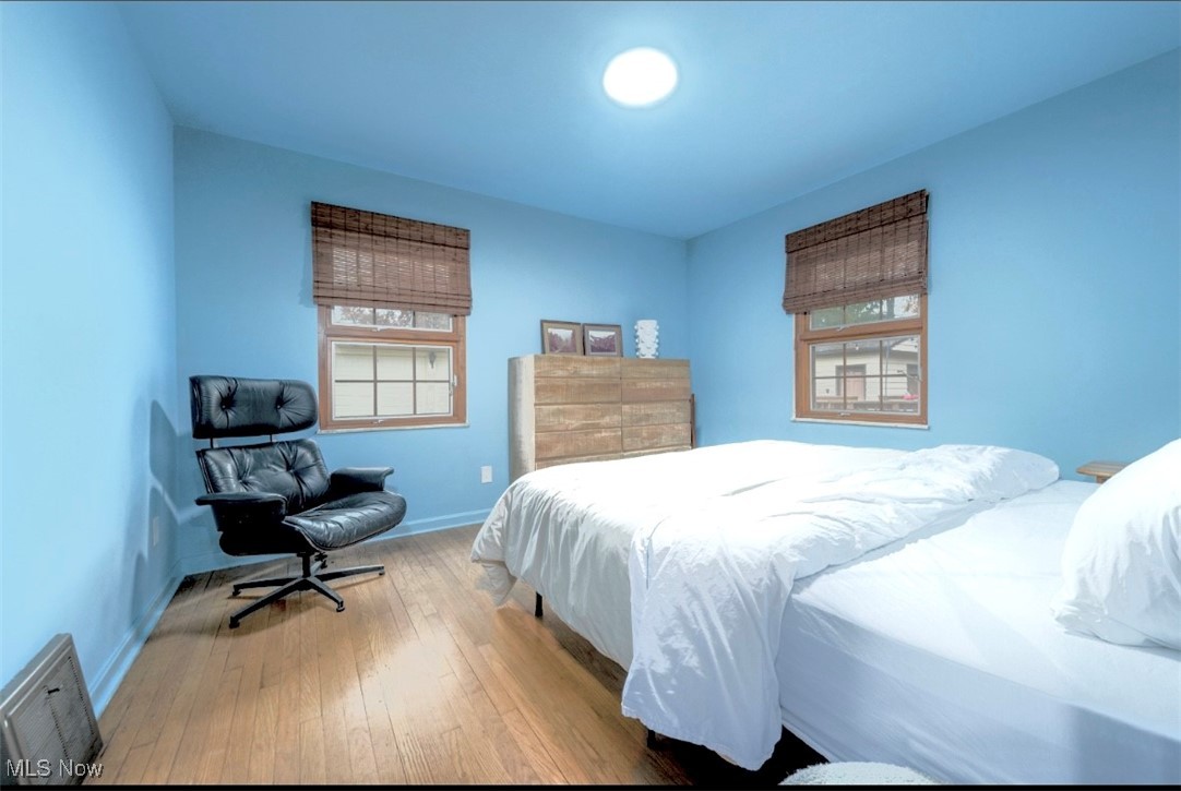 15500 Greenway Road Cleveland, OH 44111 - Photo 21 of 36 Bedroom featuring wood-type flooring and multiple windows