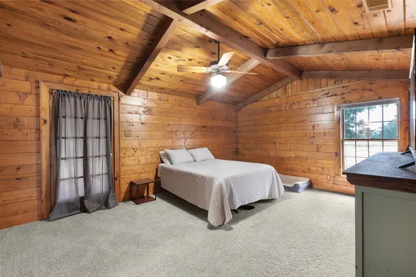 a spacious bedroom with a bed and a table
