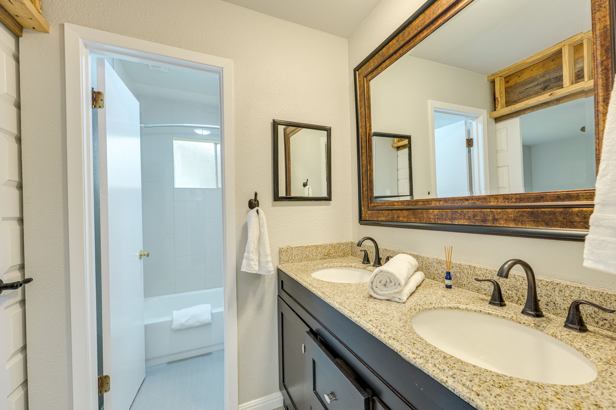 4815 Transit Circle Austin, TX 78727 - Photo 25 of 35 Double vanity featuring undermount sinks, bronze faucets, and a light-colored speckled countertop
