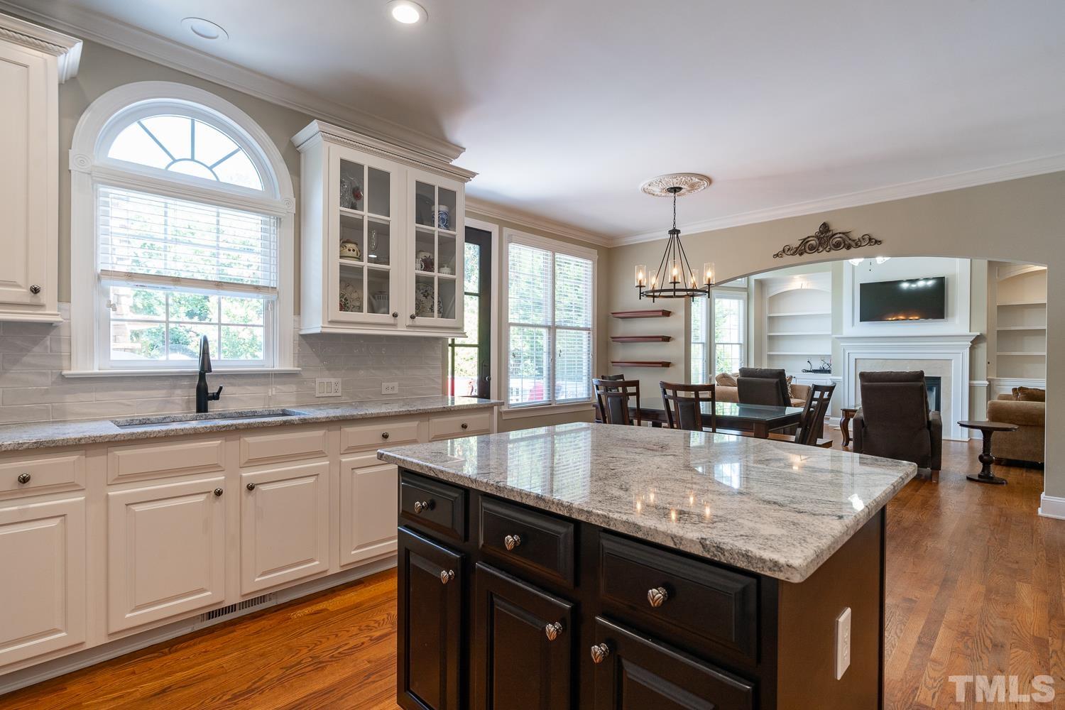 2001 Lowery Farm Lane Raleigh, NC 27614 - Photo 11 of 33 a kitchen with granite countertop a center island and windows