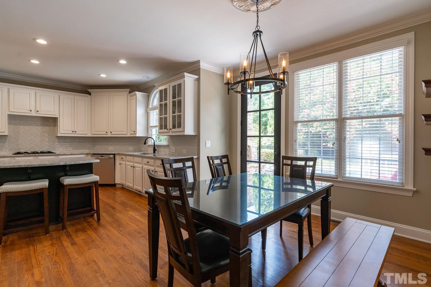 2001 Lowery Farm Lane Raleigh, NC 27614 - Photo 12 of 33 a view of a dining room with furniture window and wooden floor
