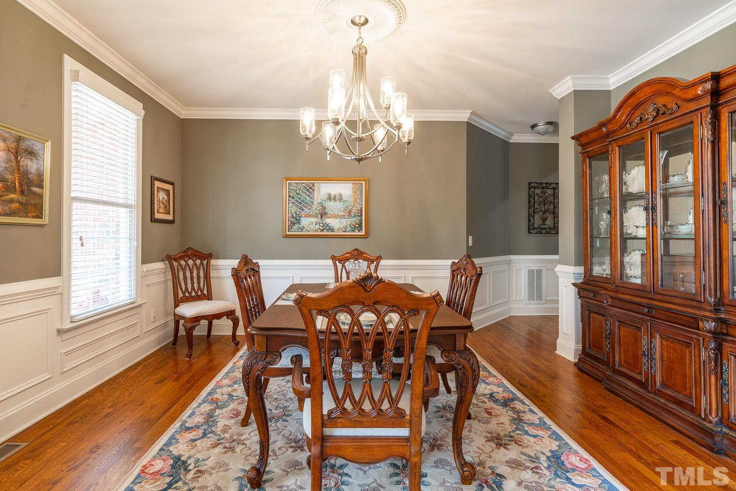 2001 Lowery Farm Lane Raleigh, NC 27614 - Photo 16 of 33 a view of a dining room with furniture a chandelier and wooden floor