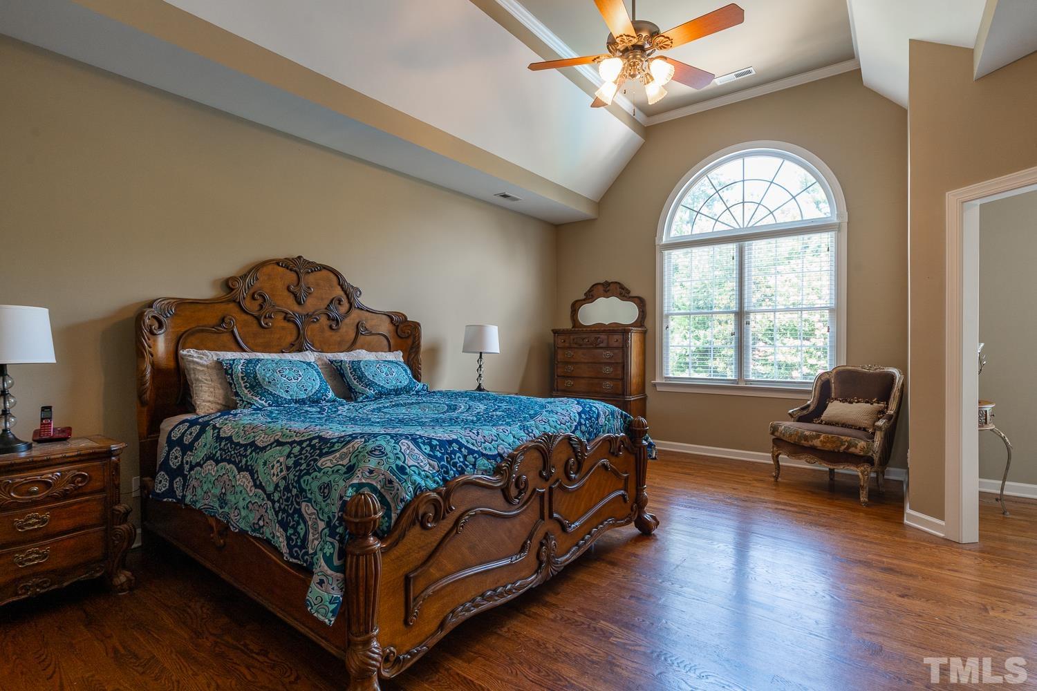 2001 Lowery Farm Lane Raleigh, NC 27614 - Photo 19 of 33 a bedroom with a bed and a chandelier