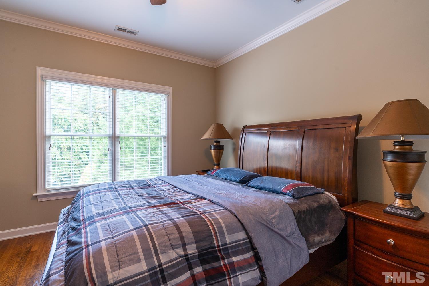 2001 Lowery Farm Lane Raleigh, NC 27614 - Photo 23 of 33 a bedroom with a bed and flat screen tv