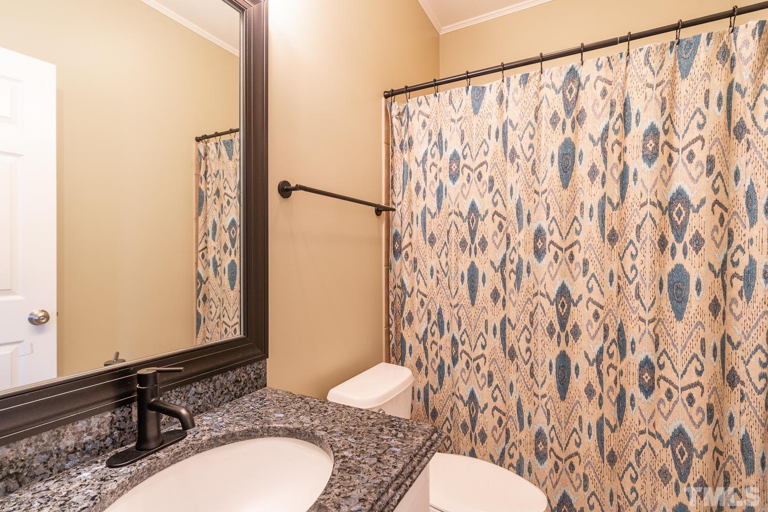 2001 Lowery Farm Lane Raleigh, NC 27614 - Photo 27 of 33 a bathroom with a sink and a mirror