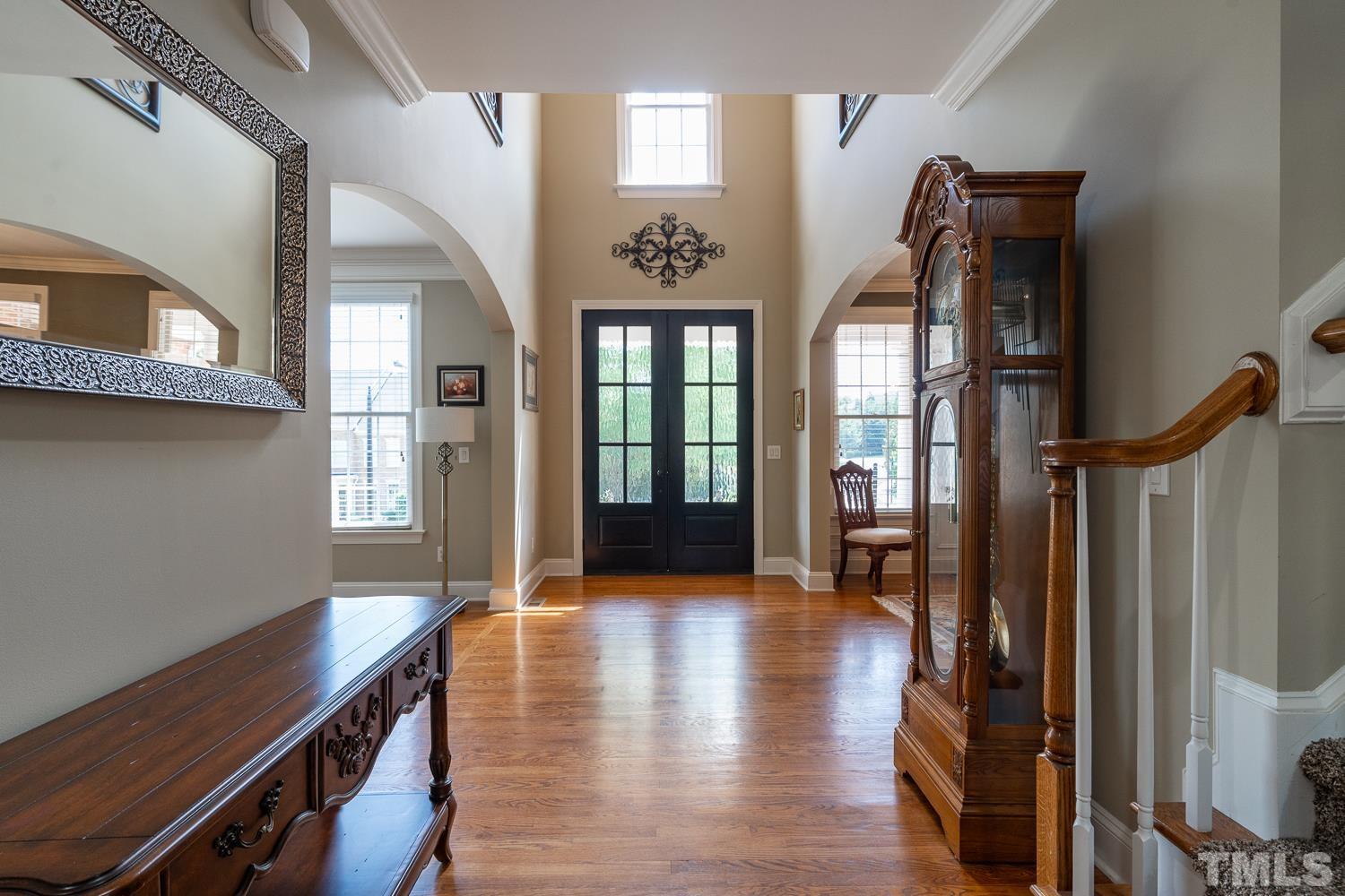 2001 Lowery Farm Lane Raleigh, NC 27614 - Photo 4 of 33 a hallway with wooden floor windows and stairs