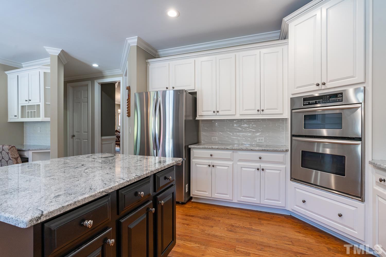 2001 Lowery Farm Lane Raleigh, NC 27614 - Photo 10 of 33 a kitchen with stainless steel appliances granite countertop a stove refrigerator and cabinets