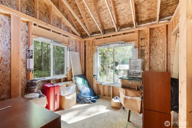 a living room with furniture and large windows