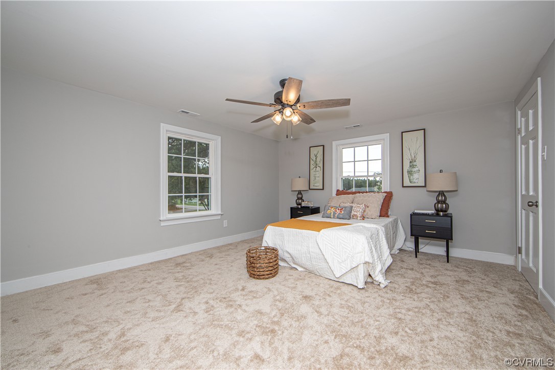 11611 Beach Road Chesterfield, VA 23838 - Photo 16 of 34 a bed room with a bed and a chandelier