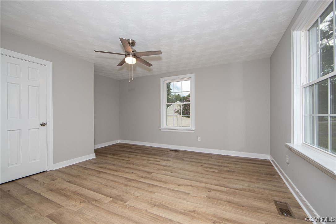 11611 Beach Road Chesterfield, VA 23838 - Photo 18 of 34 a view of empty room with wooden floor and fan