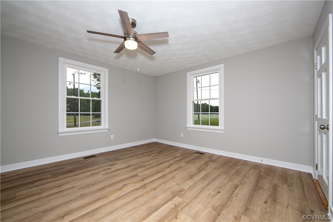 11611 Beach Road Chesterfield, VA 23838 - Photo 19 of 34 a view of an empty room with wooden floor and a window