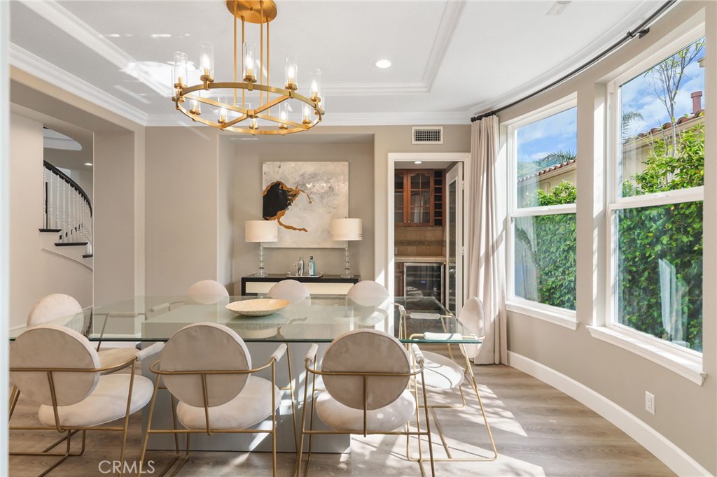 20112 Vía Cellini Porter Ranch, CA 91326 - Photo 12 of 64 a dining room with wooden floor a chandelier a glass table and chairs