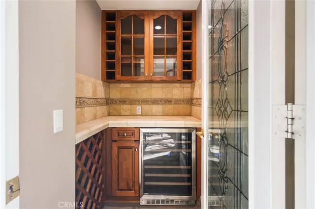 a kitchen with kitchen island stainless steel appliances a sink cabinets and wooden floor