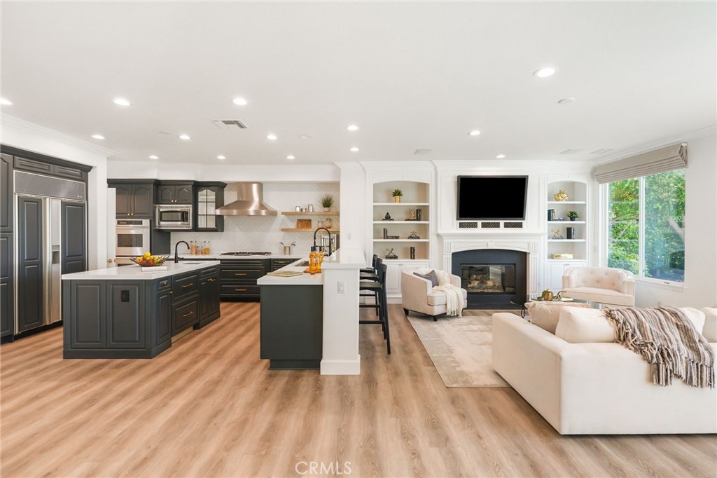 20112 Vía Cellini Porter Ranch, CA 91326 - Photo 14 of 64 a living room with furniture a fireplace and a television