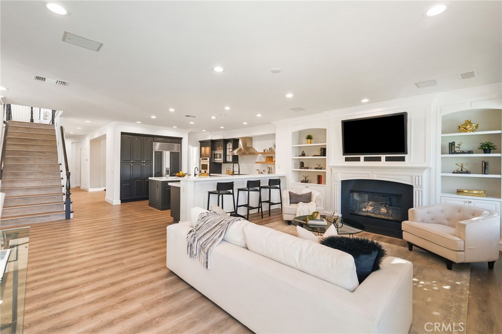 20112 Vía Cellini Porter Ranch, CA 91326 - Photo 18 of 64 a living room with furniture a fireplace and a flat screen tv