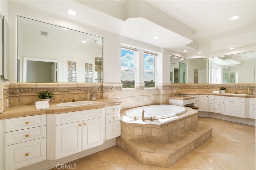 20112 Vía Cellini Porter Ranch, CA 91326 - Photo 34 of 64 a spacious bathroom with a tub double sink and mirror