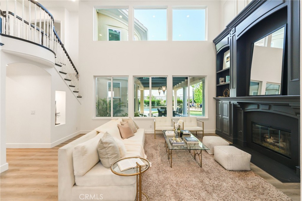 20112 Vía Cellini Porter Ranch, CA 91326 - Photo 4 of 64 a living room with furniture fireplace and a large window